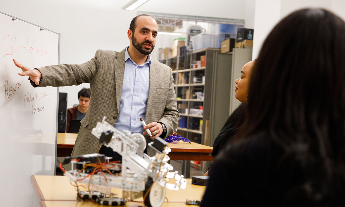 professor explaining to two students